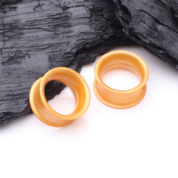 Detail View 1 of A Pair of Ultra Flexible Metallic Gold Silicone Double Flared Tunnel Plug